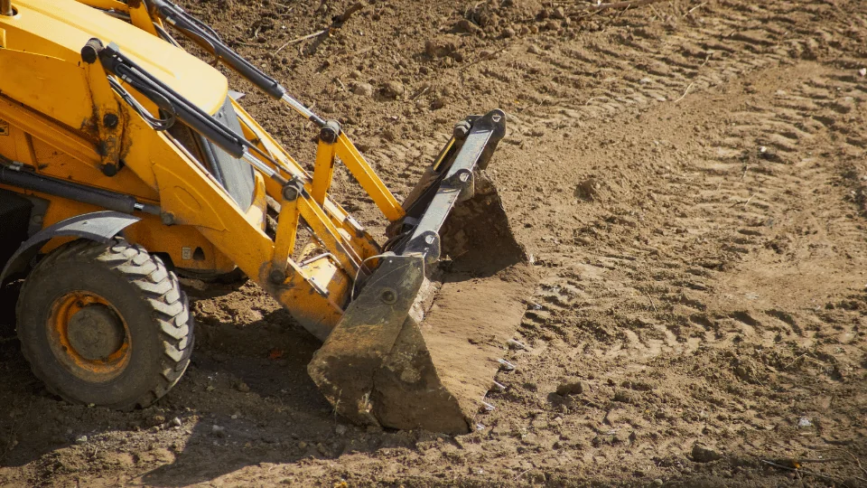 bulldozer scooping up dirt