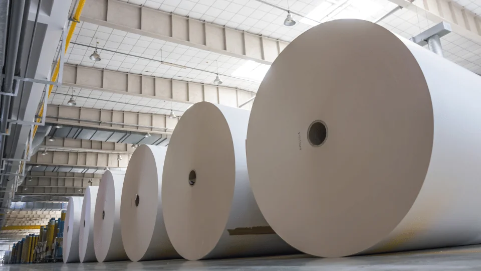 Shipping Paper and Paper Products rolls of industrial sized paper on the ground in factory