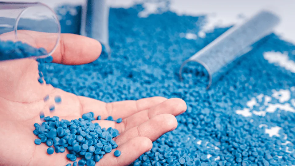 Shipping Plastics and Plastic Products hand holding blue plastic granules