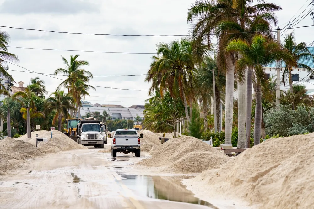 Shutterstock Image of dump trucks hauling sand after Hurricane Milton