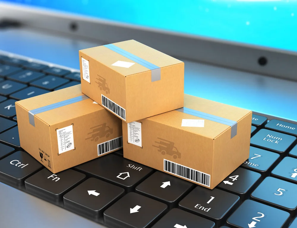 stacked cardboard boxes on laptop keyboard