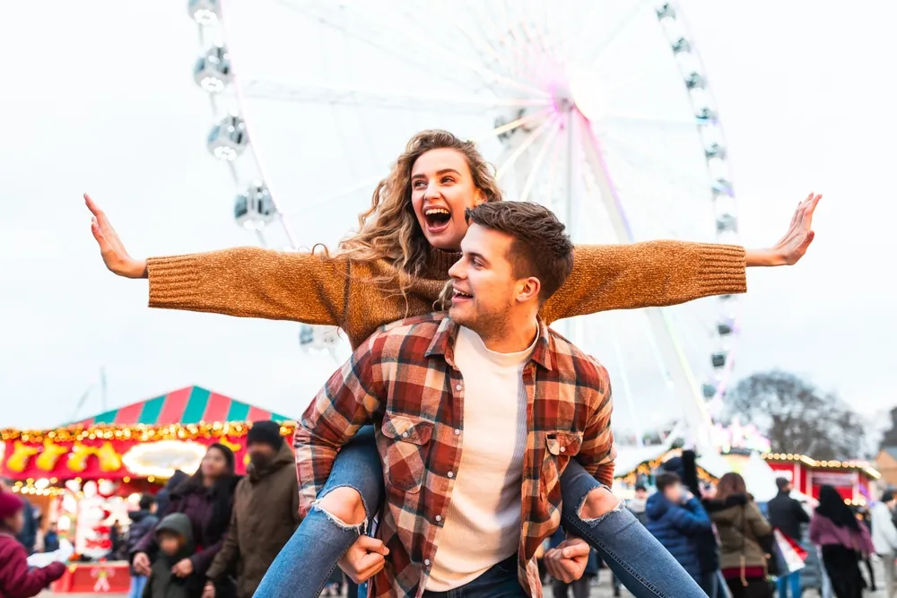 how carnival rides are freight shipped guy giving girl a piggyback ride at a carnival