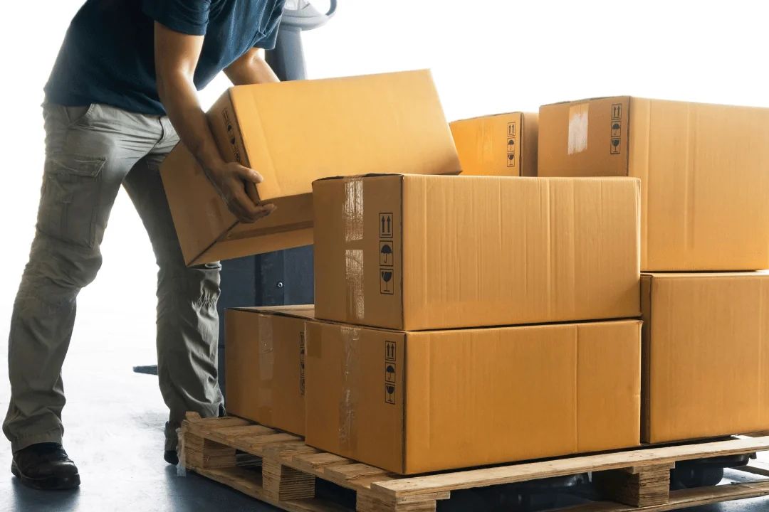 What you can do to avoid missed pickups Worker Piling Cardboard Boxes On A Pallet